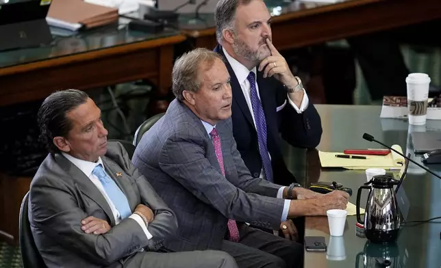 FILE - Suspended Texas state Attorney General Ken Paxton, center, sits with his attorneys Tony Buzbee, left, and Mitch Little, right, as his impeachment trial continues in the Senate Chamber at the Texas Capitol, Sept. 15, 2023, in Austin, Texas. (AP Photo/Eric Gay, File)