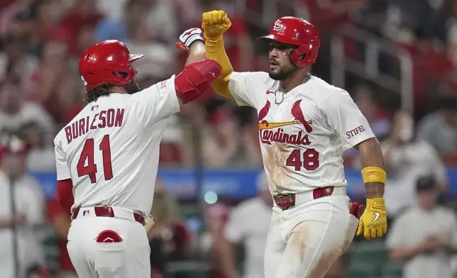 St. Louis Cardinals' Ivan Herrera (48) is congratulated by teammate Alec Burleson (41) after hitting a solo home run during the sixth inning of a baseball game against the San Diego Padres Thursday, July 24, 2025, in St. Louis. (AP Photo/Jeff Roberson)