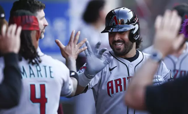 Arizona Diamondbacks' Eugenio Suárez, right, celebrates with Ketel Marte (4) after hitting a home run during the second inning of a baseball game against the Los Angeles Angels in Anaheim, Calif., Saturday, July 12, 2025. (AP Photo/Jessie Alcheh)