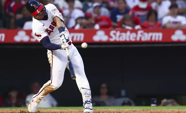 Los Angeles Angels designated hitter Mike Trout hits a home run during the fifth inning of a baseball game against the Arizona Diamondbacks in Anaheim, Calif., Saturday, July 12, 2025. (AP Photo/Jessie Alcheh)