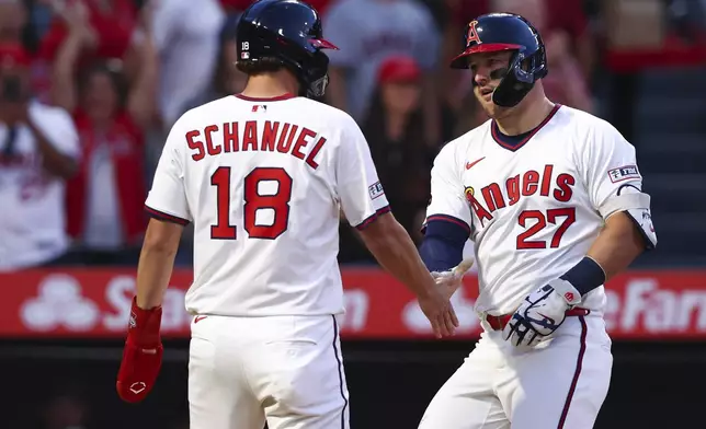 Los Angeles Angels designated hitter Mike Trout (27) celebrates with Nolan Schanuel (18) after hitting a home run during the fifth inning of a baseball game against the Arizona Diamondbacks in Anaheim, Calif., Saturday, July 12, 2025. (AP Photo/Jessie Alcheh)