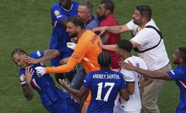 Chelsea's Joao Pedro (20) goes down after a scuffle after the Club World Cup final soccer match between Chelsea and PSG in East Rutherford, N.J., Sunday, July 13, 2025. (AP Photo/Matt Slocum)