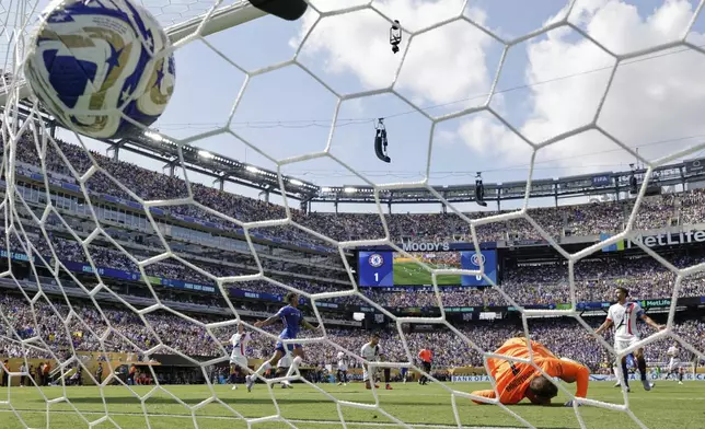 Paris Saint-Germain's goalkeeper Gianluigi Donnarumma can't make the save on the second goal scored by Chelsea's Cole Palmer during the Club World Cup final soccer match between Chelsea and PSG in East Rutherford, N.J., Sunday, July 13, 2025. (AP Photo/Adam Hunger)