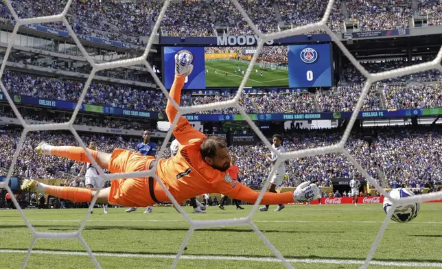 Paris Saint-Germain's goalkeeper Gianluigi Donnarumma can't make the save on the opening goal scored by Chelsea's Cole Palmer during the Club World Cup final soccer match between Chelsea and PSG in East Rutherford, N.J., Sunday, July 13, 2025. (AP Photo/Adam Hunger)