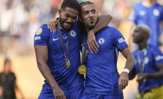 Chelsea's Reece James, left, and Malo Gusto celebrate after defeating Paris Saint-Germain in the Club World Cup final soccer match in East Rutherford, N.J., Sunday, July 13, 2025. (AP Photo/Frank Franklin II)