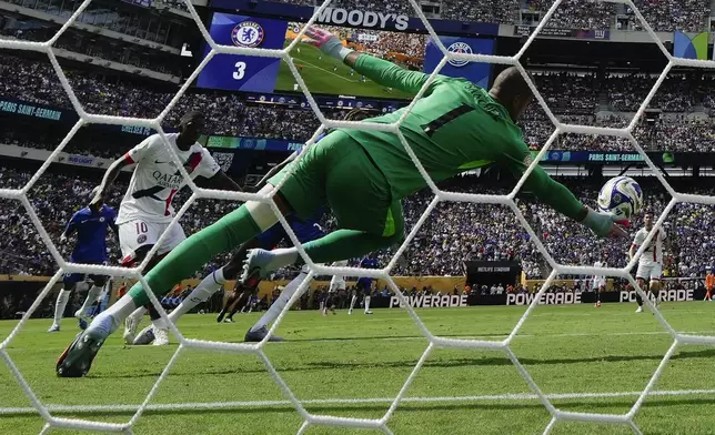 Chelsea's goalkeeper Robert Sanchez makes a save against Paris Saint-Germain during the second half of the Club World Cup final soccer match in East Rutherford, N.J., Sunday, July 13, 2025. (AP Photo/Frank Franklin II)