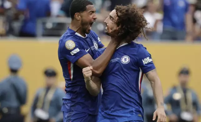 Chelsea's Marc Cucurella, right, and Chelsea's Levi Colwill celebrate after winning the Club World Cup final soccer match against PSG in East Rutherford, N.J., Sunday, July 13, 2025. (AP Photo/Adam Hunger)