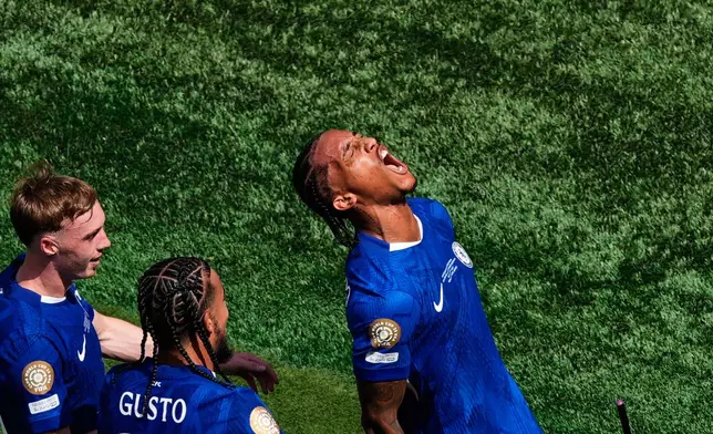 Chelsea's Joao Pedro, right, celebrates scoring his side's third goal during the Club World Cup final soccer match between Chelsea and PSG in East Rutherford, N.J., Sunday, July 13, 2025. (AP Photo/Pamela Smith)