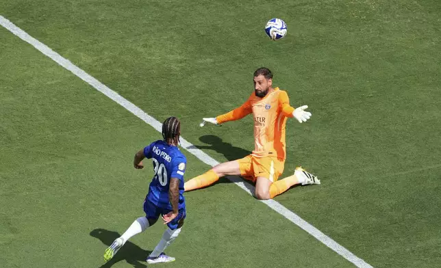 Chelsea's Joao Pedro, left, scores his side's 3rd goal in front of Paris Saint-Germain's goalkeeper Gianluigi Donnarumma during the Club World Cup final soccer match between Chelsea and PSG in East Rutherford, N.J., Sunday, July 13, 2025. (AP Photo/Pamela Smith)