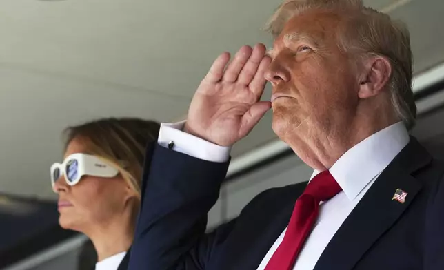 President Donald Trump, right, salutes alongside first lady Melania Trump as they attend the Club World Cup final soccer match, at MetLife Stadium in East Rutherford, N.J., Sunday, July 13, 2025. (AP Photo/Jacquelyn Martin)