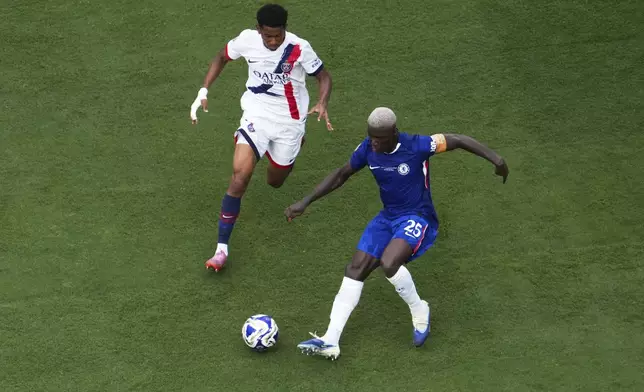 Chelsea's Moises Caicedo (25) gets past Paris Saint-Germain's Senny Mayulu (24) during the Club World Cup final soccer match between Chelsea and PSG in East Rutherford, N.J., Sunday, July 13, 2025. (AP Photo/Matt Slocum)