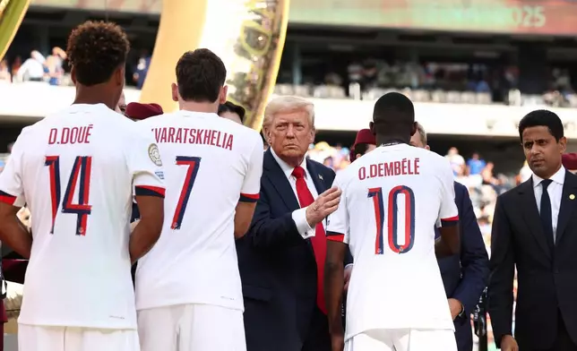 President Donald Trump looks on as he presents Paris St. Germain's Ousmane Dembele the runners up medal after Chelsea won against Paris St Germain in the Club World Cup final, at the MetLife Stadium in East Rutherford, N.J., Sunday, July 13, 2025. (Kevin Lamarque/Pool Photo via AP)
