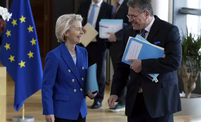 FILE - European Commissioner for Trade and Economic Security Maros Sefcovic, right, speaks with European Commission President Ursula von der Leyen, during the weekly meeting of the College of Commissioners at EU headquarters in Brussels, April 9, 2025. (AP Photo/Omar Havana, File)
