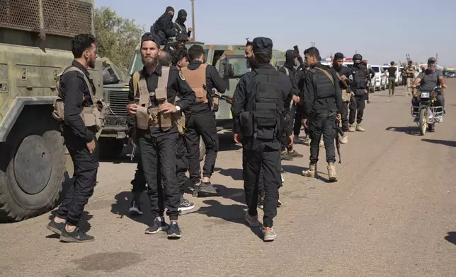 Syrian government security forces gather on the outskirts of Sweida province where clashes erupted between Druze militias and Sunni Bedouin clans, southern Syria, Monday, July 14, 2025. (AP Photo/Malek Khattab)