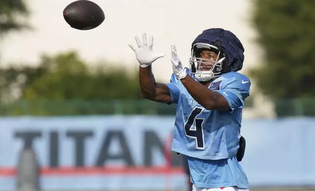 Tennessee Titans wide receiver Tyler Lockett (4) makes a catch during practice at the team's NFL football training camp Wednesday, July 30, 2025, in Nashville, Tenn. (AP Photo/George Walker IV)