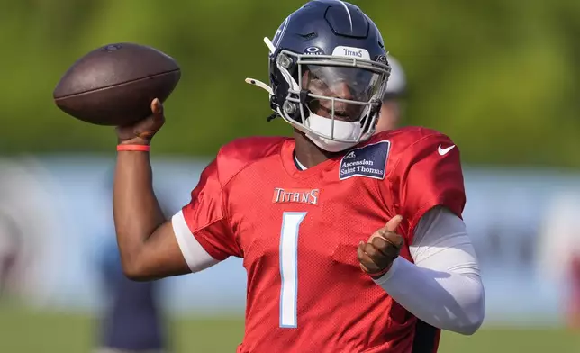 Tennessee Titans quarterback Cam Ward (1) looks to throw a pass during practice at the team's NFL football training camp Wednesday, July 30, 2025, in Nashville, Tenn. (AP Photo/George Walker IV)