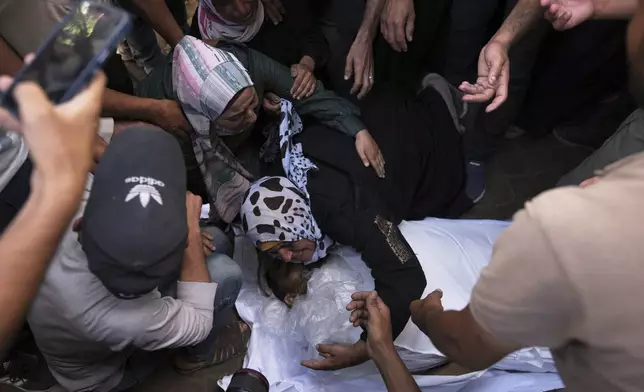 The mother of Anas Al-Basyouni mourns his loss shortly after he was killed while on his way to an aid distribution center, during his funeral at Shifa Hospital in Gaza City on Thursday, July 3, 2025. (AP Photo/Jehad Alshrafi)