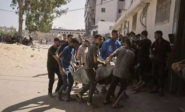 Palestinians carry the bodies of Doha Hajliya and her children into Shifa Hospital in Gaza City on Thursday, July 3, 2025, after they were killed by an Israeli airstrike that struck a school used as a shelter. (AP Photo/Jehad Alshrafi)