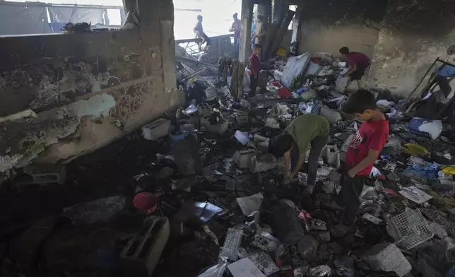 Palestinians survey the destruction at a school used as a shelter after it was struck by an Israeli airstrike in Gaza City, on Thursday, July 3, 2025. (AP Photo/Jehad Alshrafi)