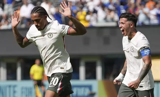 Chelsea's Joao Pedro, left, and Chelsea's Enzo Fernandez celebrate after Pedro scored a goal against Fluminense during the second half of a Club World Cup semifinal soccer match in East Rutherford, N.J., Tuesday, July 8, 2025. (AP Photo/Frank Franklin II)