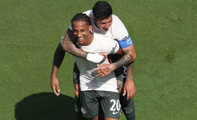 Chelsea's Joao Pedro (20) is congratulated by Enzo Fernandez after scoring his side's 2nd goal during the Club World Cup semifinal soccer match between Fluminense and Chelsea in East Rutherford, N.J., Tuesday, July 8, 2025. (AP Photo/Pamela Smith)