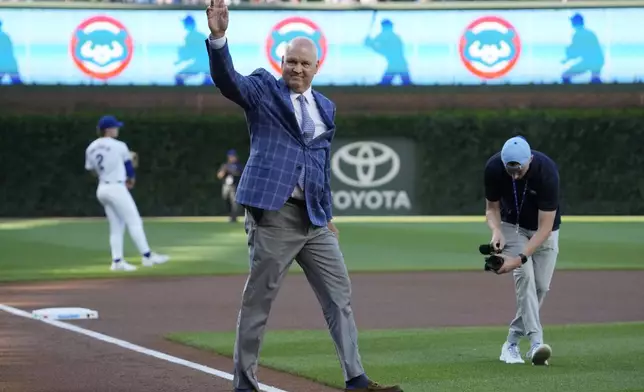 FILE - Former Chicago Cubs player Ryne Sandberg walks to the mound to throw a ceremonial first pitch before a baseball game between the New York Mets and the Cubs in Chicago, Sunday, June 23, 2024. (AP Photo/Nam Y. Huh,File)