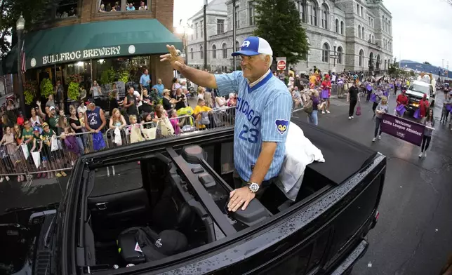 FILE - Baseball Hall of Fame infielder Ryne Sandberg, the Grand Marshall of this year's Little League Grand Slam Parade, rides through downtown Williamsport, Pa., Monday, Aug. 14, 2023. (AP Photo/Gene J. Puskar,File)