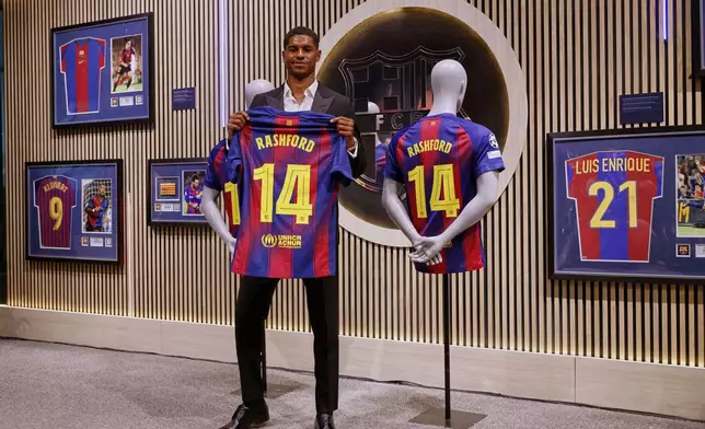 Marcus Rashford poses with an F.C. Barcelona jersey during his presentation as a new signing in Barcelona, Spain, Wednesday, July 23, 2025. (AP Photo/Joan Monfort)