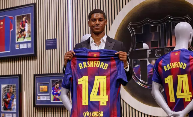 Marcus Rashford poses with an F.C. Barcelona jersey during his presentation as a new signing in Barcelona, Spain, Wednesday, July 23, 2025. (AP Photo/Joan Monfort)