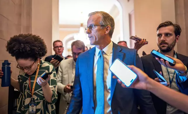 Senate Majority Leader John Thune, R-S.D., rushes from the chamber to his office as he struggles with Republicans opposed to President Donald Trump's signature bill of big tax breaks and spending cuts, at the Capitol in Washington, Tuesday, July 1, 2025. (AP Photo/J. Scott Applewhite)