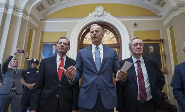 Senate Majority Leader John Thune, R-S.D., is flanked by Sen. John Barrasso, R-Wyo., the GOP whip, left, and Finance Committee Chairman Mike Crapo, R-Idaho, speaks to reporters just after passage of the budget reconciliation package of President Donald Trump's signature bill of big tax breaks and spending cuts, at the Capitol in Washington, Tuesday, July 1, 2025. The bill now moves back to the House for final consideration. (AP Photo/J. Scott Applewhite)