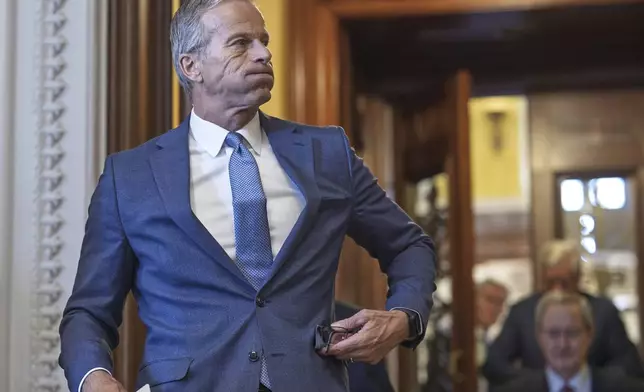 Senate Majority Leader John Thune, R-S.D., emerges from the chamber just after passage of the budget reconciliation package of President Donald Trump's signature bill of big tax breaks and spending cuts, at the Capitol in Washington, Tuesday, July 1, 2025. (AP Photo/J. Scott Applewhite)