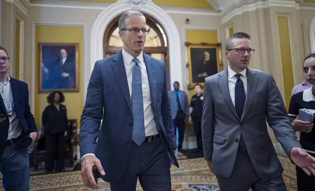 Senate Majority Leader John Thune, R-S.D., rushes from the chamber to his office as he struggles with Republicans opposed to President Donald Trump's signature bill of big tax breaks and spending cuts, at the Capitol in Washington, Tuesday, July 1, 2025. (AP Photo/J. Scott Applewhite)