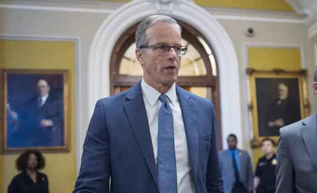 Senate Majority Leader John Thune, R-S.D., rushes from the chamber to his office as he struggles with Republicans opposed to President Donald Trump's signature bill of big tax breaks and spending cuts, at the Capitol in Washington, Tuesday, July 1, 2025. (AP Photo/J. Scott Applewhite)