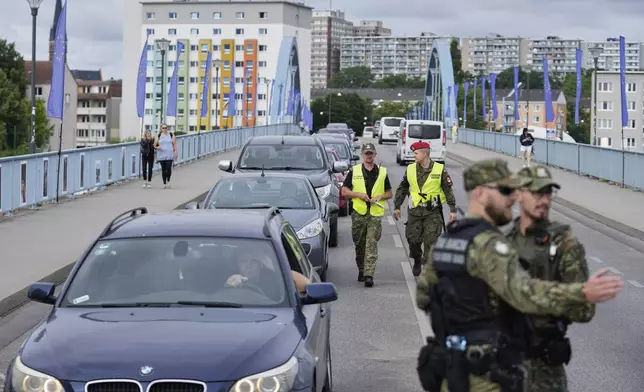Polish border police check vehicles at a checkpoint bordering Germany, in Slubice, Poland, Monday, July 7, 2025. (AP Photo/Ebrahim Noroozi)