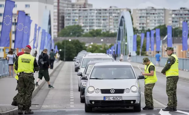 Polish border police check vehicles at a checkpoint bordering Germany, in Slubice, Poland, Monday, July 7, 2025. (AP Photo/Ebrahim Noroozi)