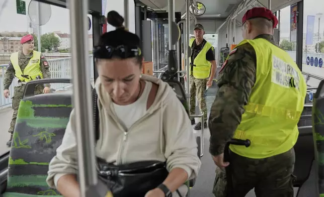 Polish border police check passengers on a bus at a checkpoint bordering Germany, in Slubice, Poland, Monday, July 7, 2025. (AP Photo/Ebrahim Noroozi)