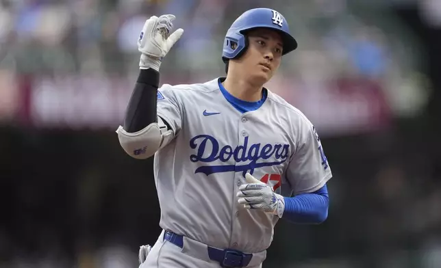 Los Angeles Dodgers' Shohei Ohtani gestures as he rounds the bases after hitting a solo home run during the first inning of a baseball game against the Milwaukee Brewers, Tuesday, July 8, 2025, in Milwaukee. (AP Photo/Aaron Gash)