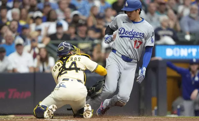 Los Angeles Dodgers' Shohei Ohtani (17) is tagged out at home plate by Milwaukee Brewers' William Contreras during the sixth inning of a baseball game Tuesday, July 8, 2025, in Milwaukee. (AP Photo/Aaron Gash)