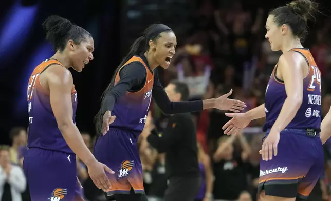 Phoenix Mercury forwards Alyssa Thomas, left, DeWanna Bonner, center, and Kathryn Westbeld (24) celebrate a score against the Minnesota Lynx during the second half of a WNBA basketball game Wednesday, July 9, 2025, in Phoenix. (AP Photo/Ross D. Franklin)