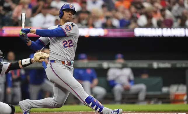 New York Mets' Juan Soto (22) strikes out swinging during the first inning of a baseball game against the Baltimore Orioles, Tuesday, July 8, 2025, in Baltimore. (AP Photo/Stephanie Scarbrough)