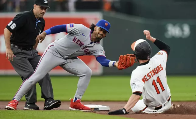 Baltimore Orioles' Jordan Westburg (11) is caught stealing second base by New York Mets shortstop Francisco Lindor (12) during the first inning of a baseball game, Tuesday, July 8, 2025, in Baltimore. (AP Photo/Stephanie Scarbrough)