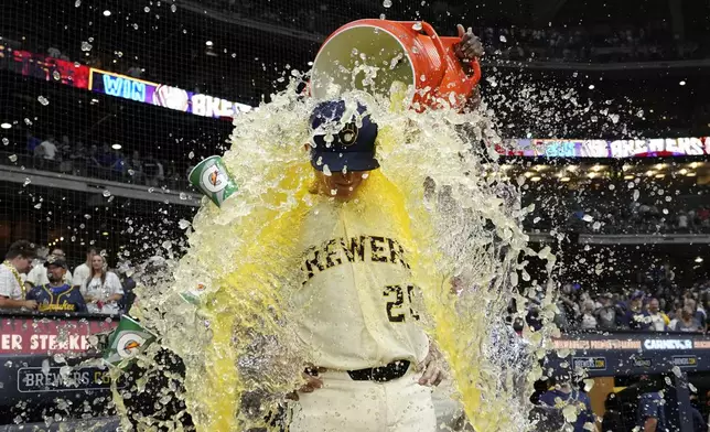 Milwaukee Brewers' Andrew Vaughn (28) gets splashed by Andruw Monasterio after a baseball game against the Chicago Cubs, Tuesday, July 29, 2025, in Milwaukee. (AP Photo/Aaron Gash)