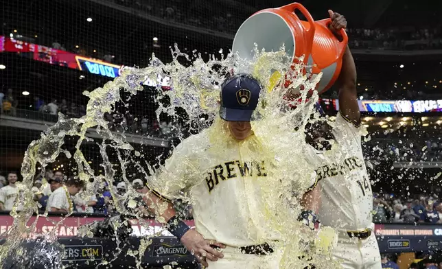 Milwaukee Brewers' Andrew Vaughn, left, gets splashed by Andruw Monasterio after a baseball game against the Chicago Cubs, Tuesday, July 29, 2025, in Milwaukee. (AP Photo/Aaron Gash)