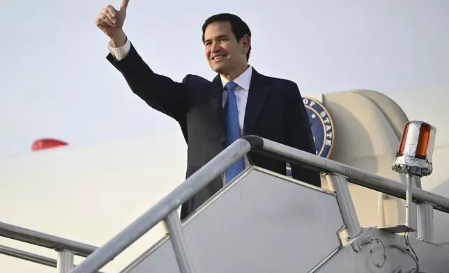 US Secretary of State Marco Rubio gestures as he boards his flight before departing from Subang Air Base, on the outskirts of Kuala Lumpur, on Friday, July 11, 2025, after attending the 58th ASEAN Foreign Ministers' meeting. (Mandel Ngan/Pool Photo via AP)
