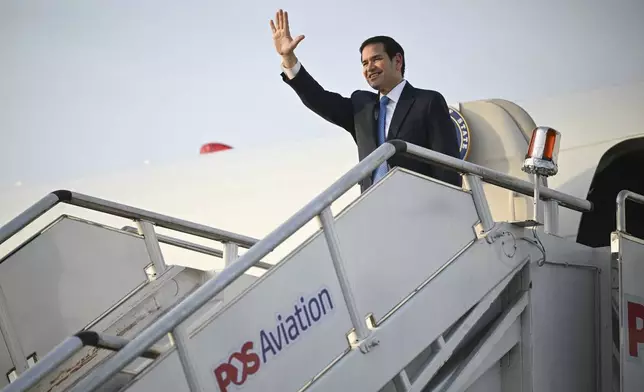 US Secretary of State Marco Rubio gestures as he boards his flight before departing from Subang Air Base, on the outskirts of Kuala Lumpur, on Friday, July 11, 2025, after attending the 58th ASEAN Foreign Ministers' meeting. (Mandel Ngan/Pool Photo via AP)