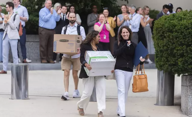 State Department employees cheer to recognize the service of their fired co-workers who are carrying boxes and their personal belongings out of the Harry S. Truman Building, the headquarters of the State Department, in Washington, Friday, July 11, 2025, as they , (AP Photo/Manuel Balce Ceneta)