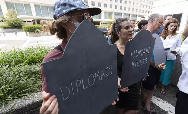 Retired State Department employees and supporters rally outside the Harry S. Truman Building, the headquarters of the State Department, in Washington, Friday, July 11, 2025. (AP Photo/Manuel Balce Ceneta)