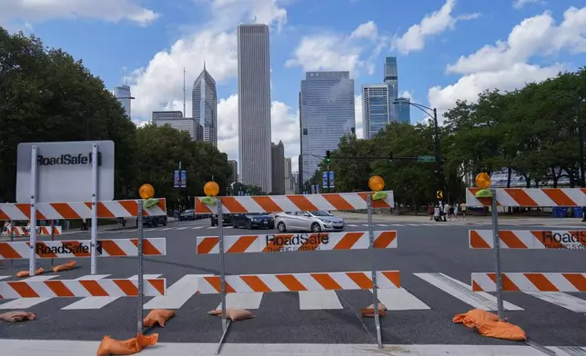Construction of the street course continues ahead of the NASCAR auto racs, Friday, June 27, 2025, in downtown Chicago. (AP Photo/Erin Hooley)