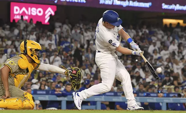Los Angeles Dodgers' Will Smith, right, hits a walk-off home run as San Diego Padres catcher Elias Diaz watches during the ninth inning of a baseball game Wednesday, June 18, 2025, in Los Angeles. (AP Photo/Mark J. Terrill)